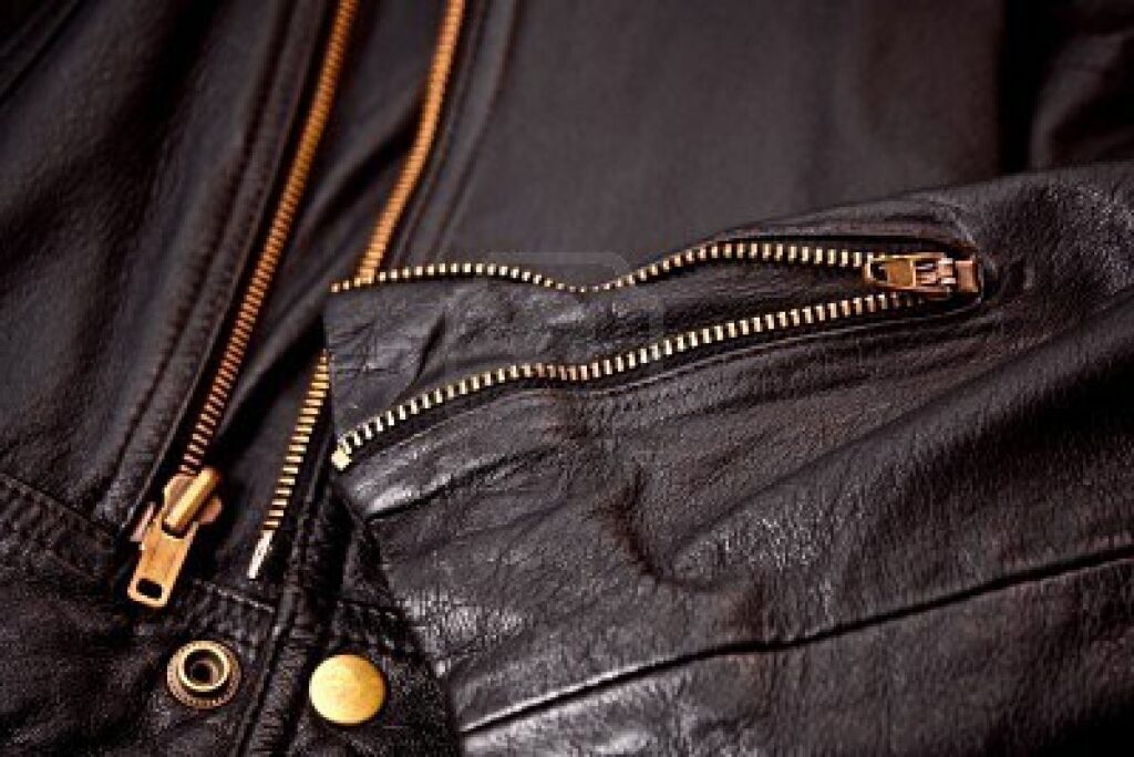 3836106 detail of sleeve and brass zippers of leather jacket