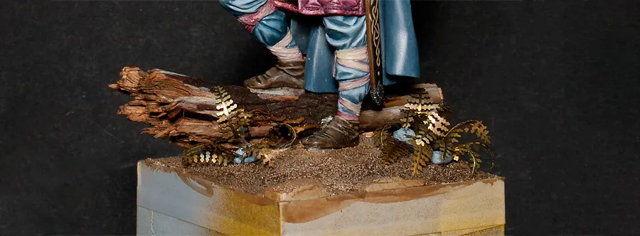Dry-fitting brass-etched fern leaves to the scenic base - Minichix Studio tutorial on building miniature base.