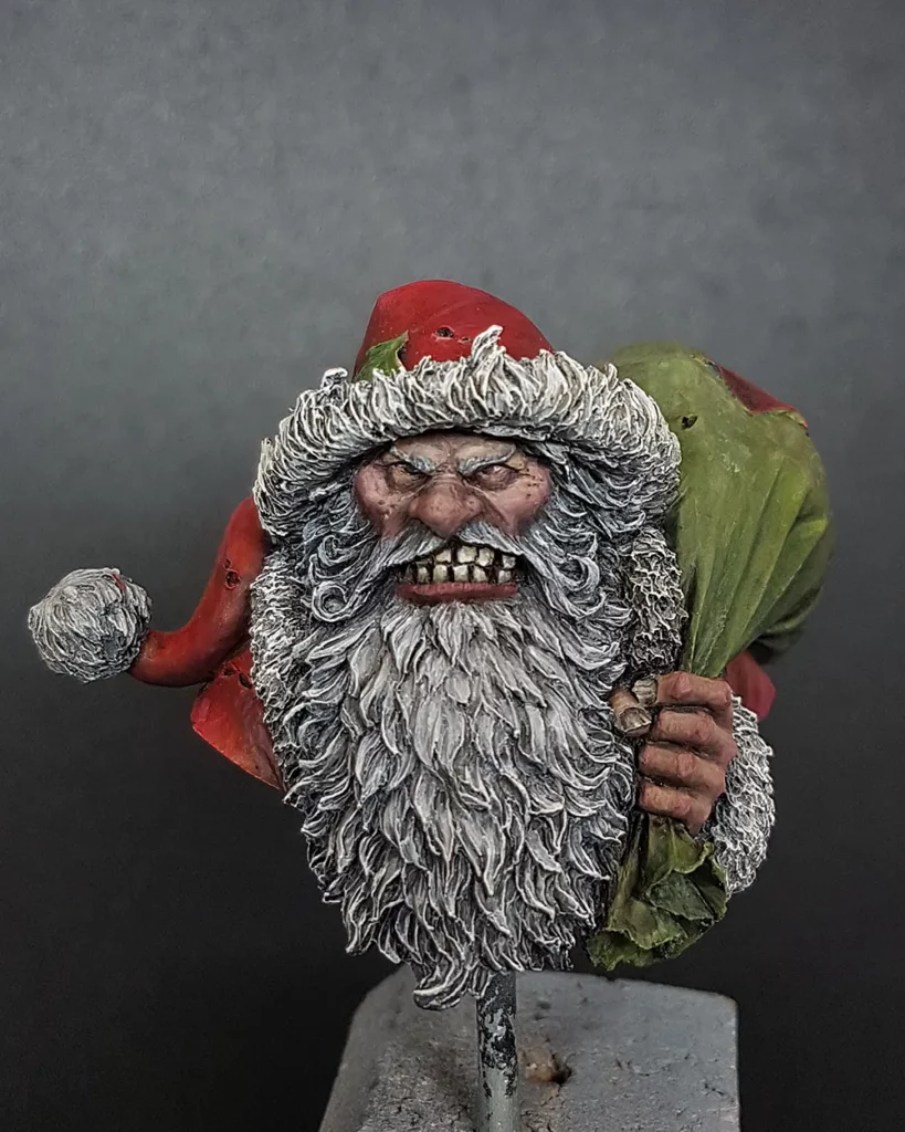 Colour photo of WIP of Bad Santa bust by Latorre featured in Minichix Studio article on checking contrast in miniature painting