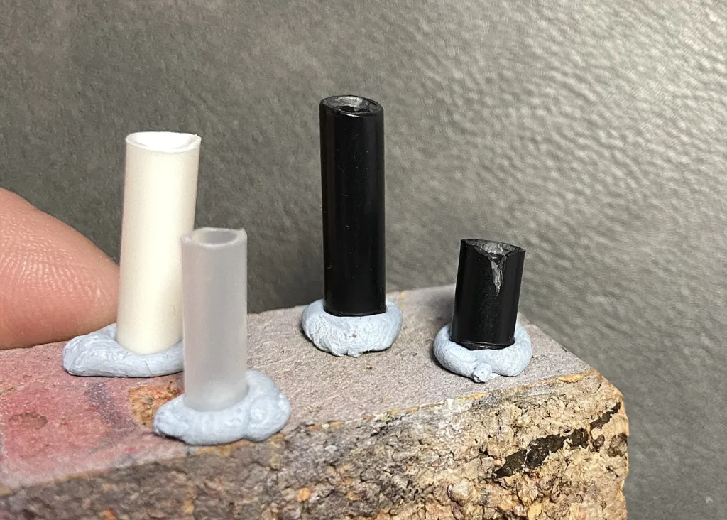 Securing the cut tubes to cork base with Blue-Tac in the creation of miniature candles - step-by-step scenic base tutorial by Minichix Studio